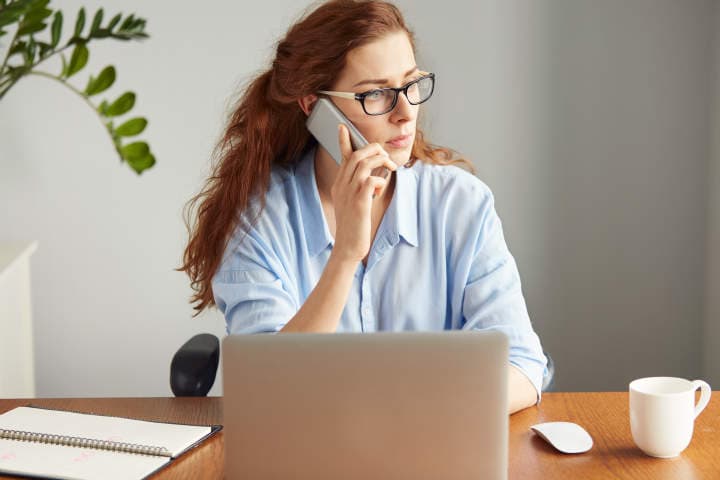 Woman on phone looking frustrated